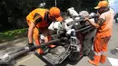 Petugas menggunakan mobil pick up untuk mengangkut kulit kabel yang ditemukan di gorong-gorong saluran air Jalan Gatot Subroto, Jakarta, Senin (6/3). Tumpukan kulit kabel ini dianggap menjadi penyebab utama terjadinya banjir. (Liputan6.com/Johan Tallo)