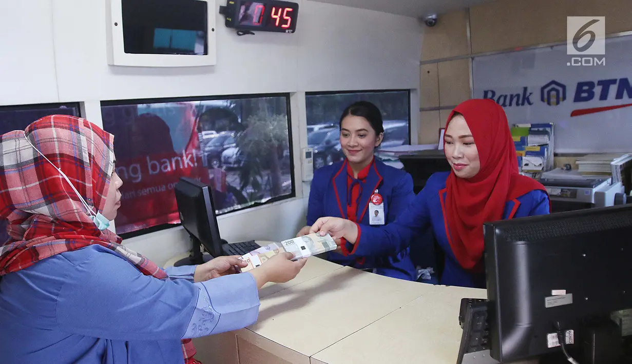 Seorang wanita menukarkan uang pecahan kecil pada mobil kas keliling Bank BTN di Lapangan IRTI Monas, Jakarta, Rabu (7/6). Bank Indonesia bekerja sama dengan 13 bank lainnya melayani penukaran uang hingga 16 Juni mendatang. (Liputan6.com/Angga Yuniar)