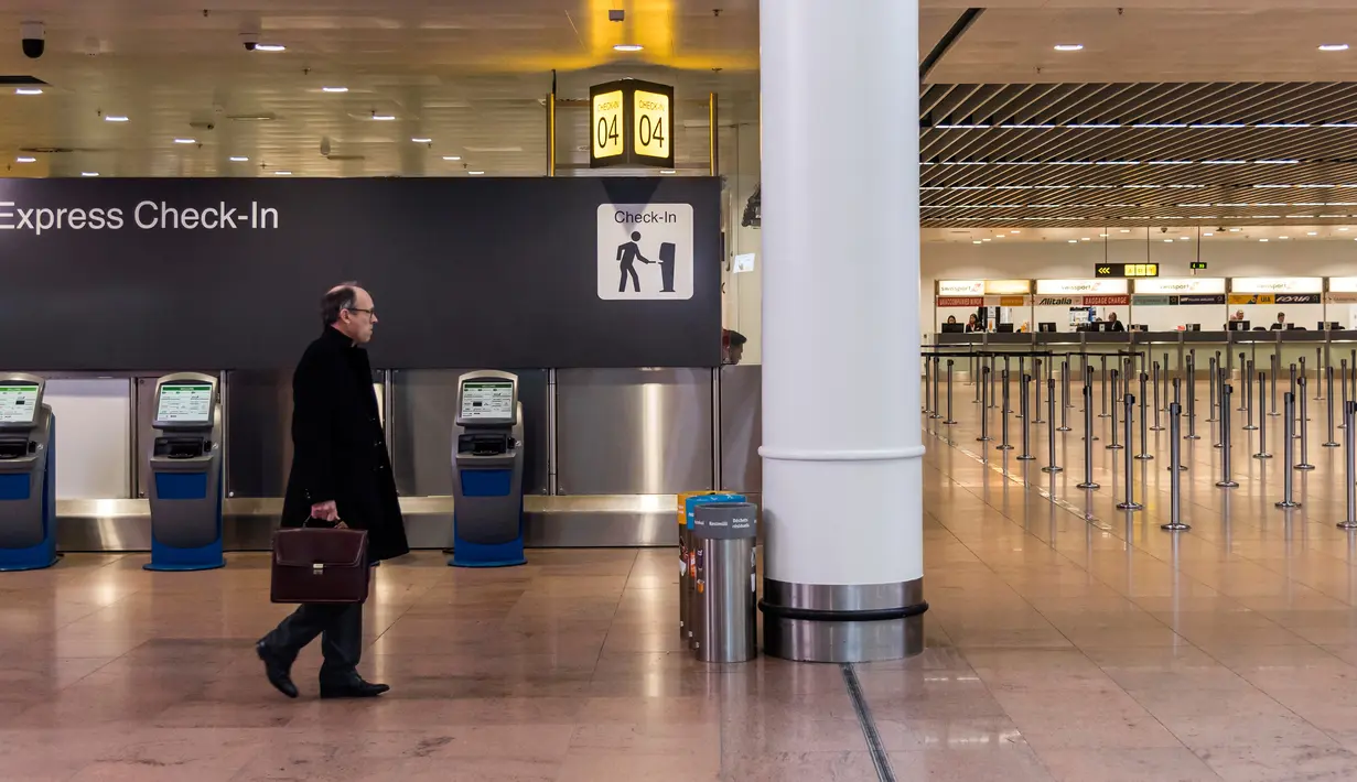 Seorang penumpang melihat layar informasi keberangkatan di Bandara Brussels, Zaventem, Belgia, Rabu (13/2). Menurut badan lalu lintas udara Skeyes, pembatalan penerbangan di Belgia berkaitan dengan aksi mogok nasional. (AP Photo/Geert Vanden Wijngaert)