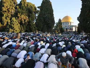 Umat Muslim melaksanakan sholat Idul Fitri di luar masjid Kubah Batu di kompleks masjid Al-Aqsa, Yerusalem Tua (13/5/2021).  Beberapa malam bentrokan antara pengunjuk rasa Palestina dan polisi Israel, terutama di sekitar masjid Al-Aqsa, meningkat awal pekan ini. (AFP/Ahmad Gharabli)
