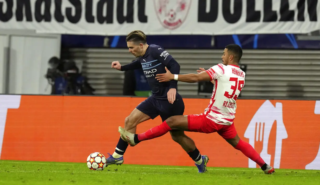 Pemain Manchester City Jack Grealish (kiri)) berduel memperebutkan bola dengan pemain RB Leipzig Benjamin Henrichs pada pertandingan sepak bola Grup A Liga Champions di Red Bull Arena, Leipzig, Jerman, 7 Desember 2021. RB Leipzig menang 2-1. (AP Photo/Michael Sohn)