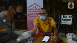 Tim medis mengecek kesehatan warga sebelum mendapatkan vaksin booster di Jakarta, Rabu (6/4/2022). Kegiatan vaksinasi booster ini digelar sampai jelang mudik, dimana saat ini 503 gerai vaskin yang tersebar di wilayah hukum Polda Metro Jaya. (merdeka.com/Imam Buhori)