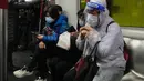 Penumpang mengenakan masker dan pelindung wajah, duduk di kereta di Hong Kong, 23 Februari 2022. Warga Hong Kong semakin kesal dengan desakan pemerintah untuk tetap berpegang pada strategi "nol-COVID" ketika kota itu mencatat rekor jumlah kasus baru lainnya pada hari Rabu. (AP Photo/Vincent Yu)