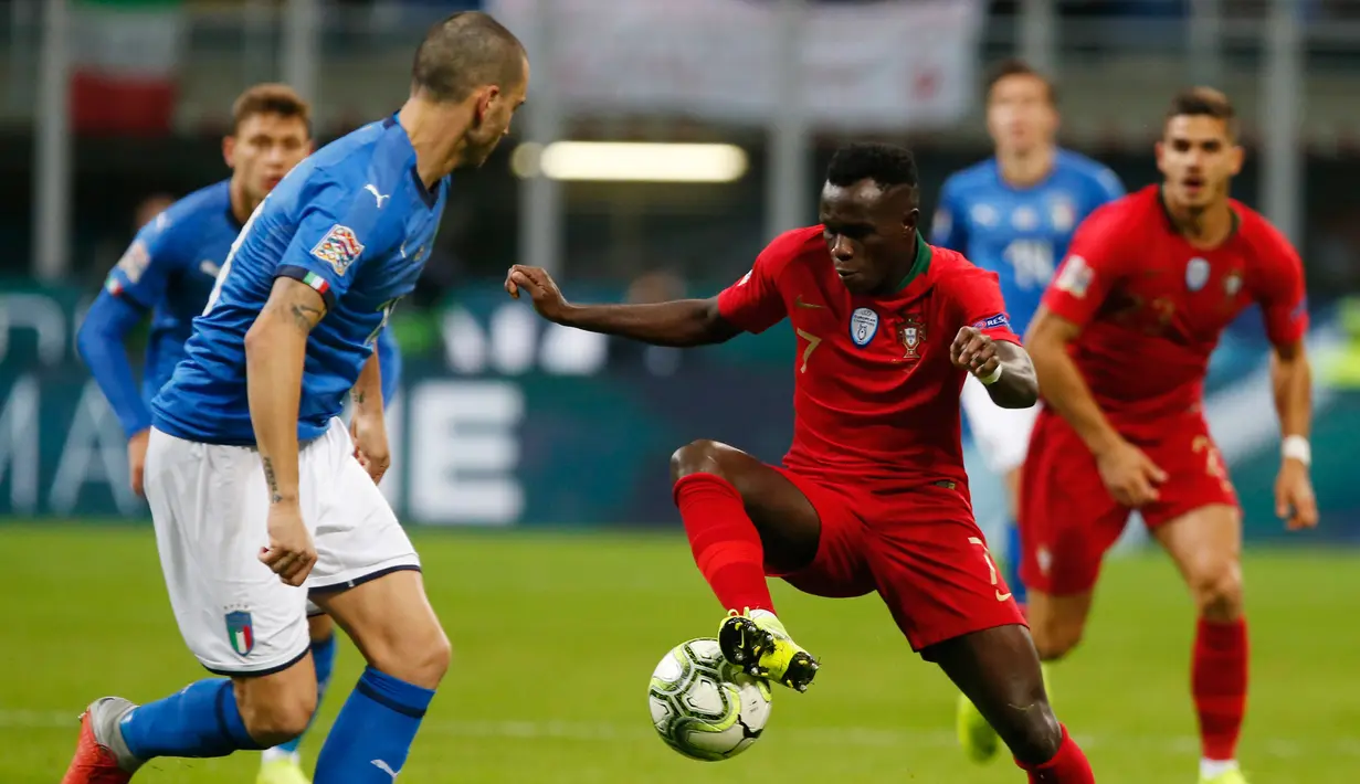 Bek Italia, Leonardo Bonucci berusaha merebut bola yang dibawa pemain Portugal, Brumavie selama pertandingan UEFA Nations League di Stadion San Siro di Milan (17/11). Portugal berhasil lolos ke semifinal. (AP Photo/Antonio Calanni)