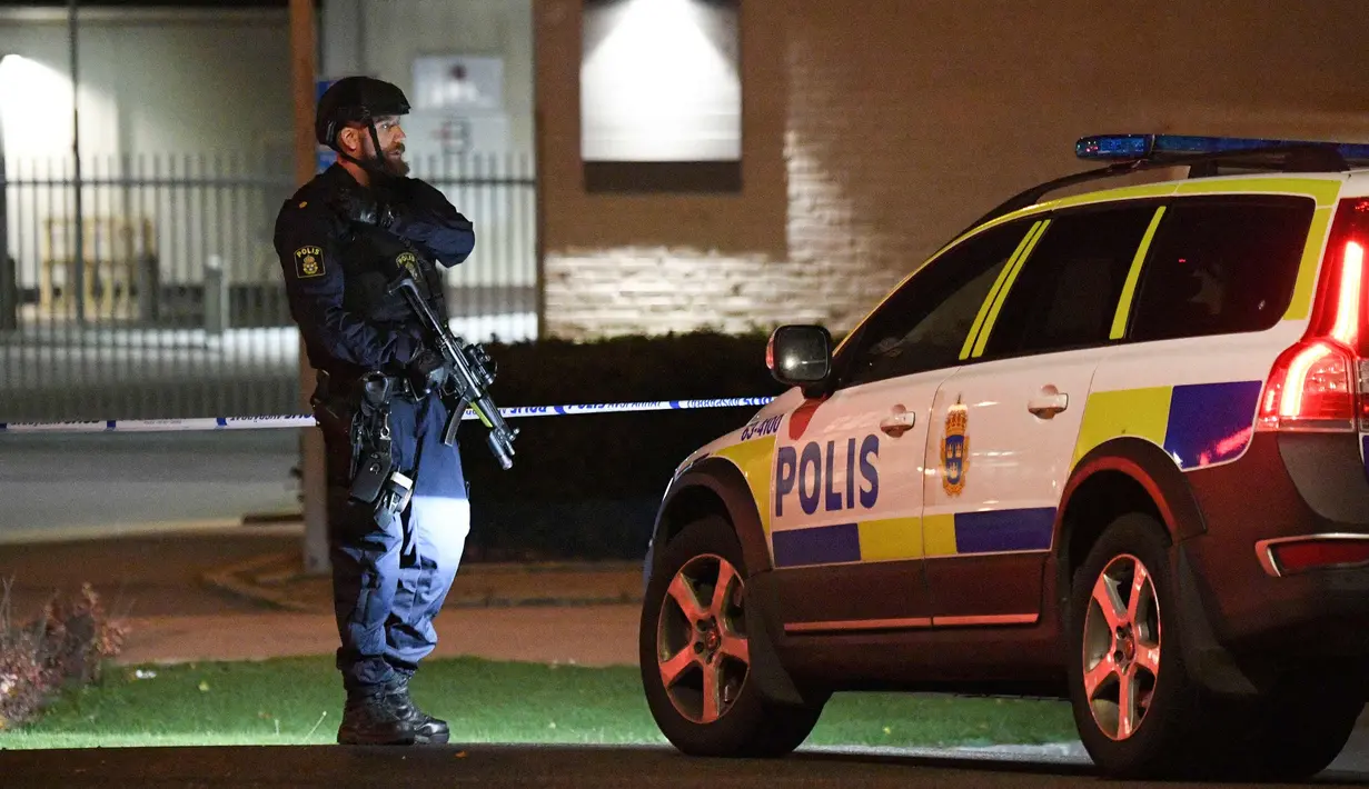 Petugas berjaga di areal kantor polisi yang meledak di Helsingborg, Swedia (18/10). Kejahatan mengalami peningkatan di Swedia Selatan dengan banyaknya penembakan di wilayah tersebut. (AFP Photo/TT News Agency /Johan Nilsson/Sweden Out)