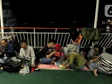 Aktivitas pemudik saat berada di kapal penyeberangan di Pelabuhan Ciwandan, Banten, Kamis (27/3/2025). (Liputan6.com/Herman Zakharia)