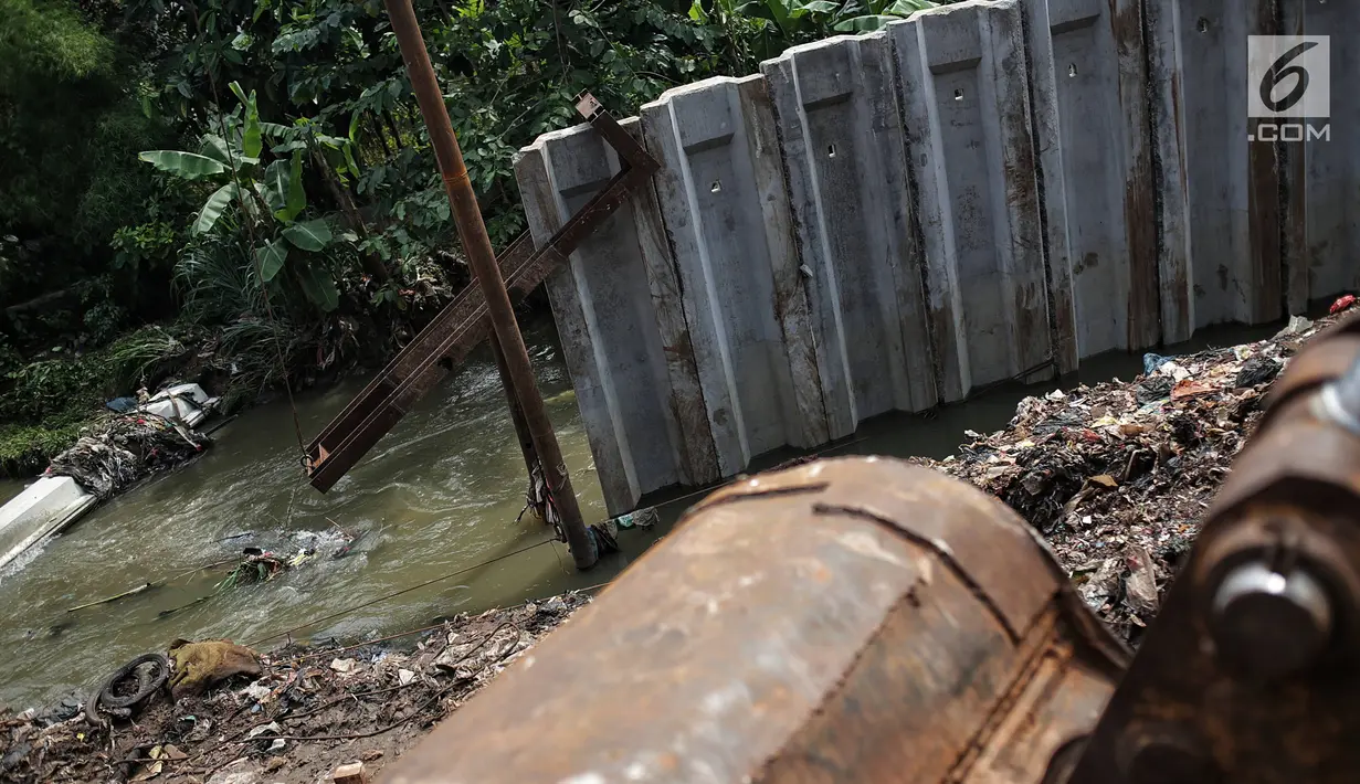 Proyek tiang pancang turap aliran anak kali ciliwung yang terbengkalai di kawasan Jalan Gudang Air, Jakarta, Selasa (12/2).Pengerjaan yang tak kunjung selesai menyebabkan jalan hadidji dan sekitar kerap banjir jika hujan deras.(Liputan6.com/Faizal Fanani)