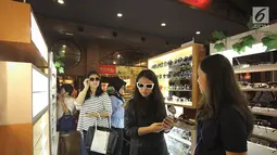 Sejumlah pengunjung mencoba kaca mata di salah satu stand bazar dalam acara Fimela Fest 2018, Jakarta, Jumat (16/11). Fimela Fest 2018 diselenggarakan mulai tanggal 13-18 November 2018 di Gandaria City Mall, Jakarta. (Fimela.com/Bambang Ekoros Purnama)