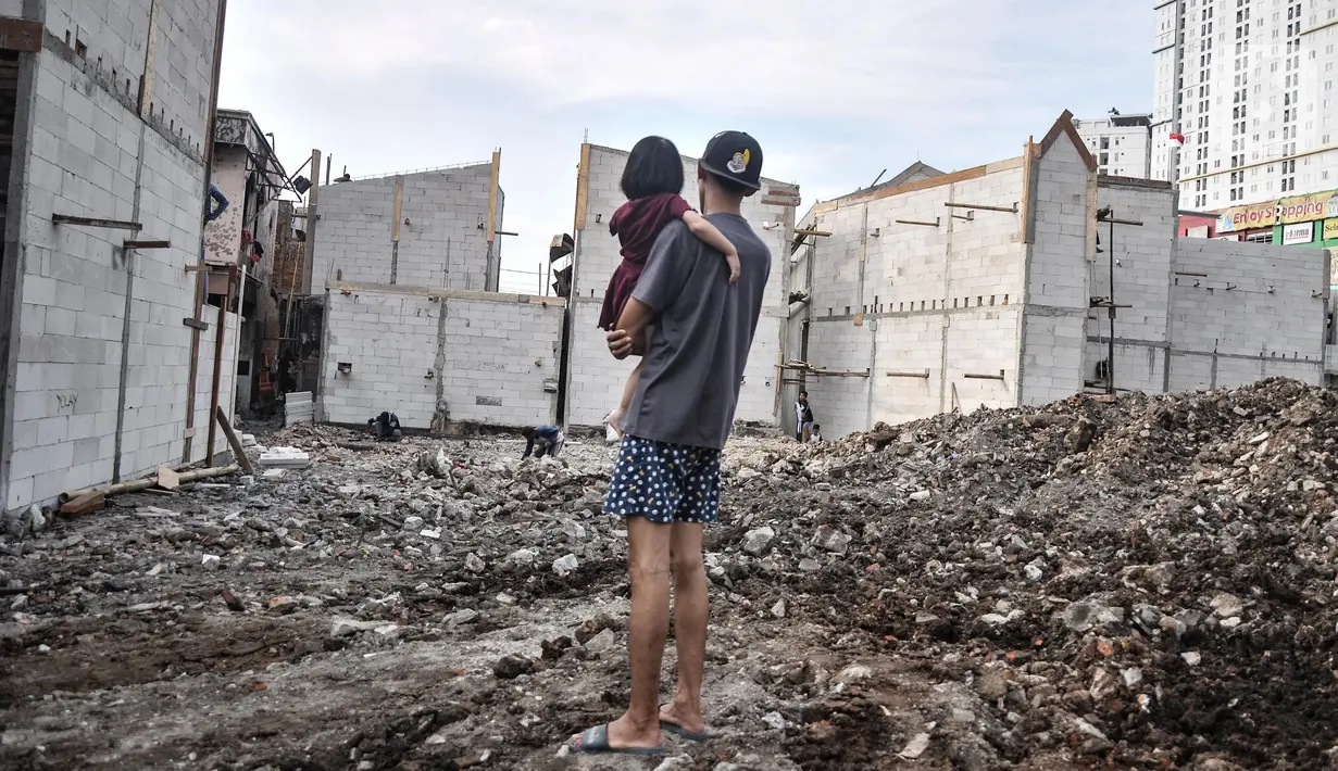 Warga saat menyaksikan pembangunan Kampung Gembira Gembrong, Cipinang Besar Utara, Jakarta Timur, Senin (1/8/2022). Wali Kota Jakarta Timur Muhammad Anwar mengungkapkan progres revitalisasi Kampung Gembira Gembrong saat ini telah mencapai 50 persen. Sebanyak 76 unit rumah telah dibangun dari target 136 unit yang dikhususkan untuk warga korban kebakaran Pasar Gembrong. (merdeka.com/Iqbal S. Nugroho)