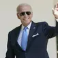 Presiden Amerika Serikat Joe Biden melambaikan tangan usai berbicara di Taman Mawar Gedung Putih, Washington, Amerika Serikat, 27 Juli 2022. Selain masih harus mengenakan masker, Biden juga harus terus melakukan tes virus secara teratur jika terjadi gejala lagi. (AP Photo/Susan Walsh)