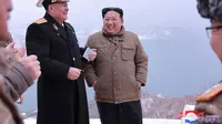 Dalam foto yang disediakan oleh pemerintah Korea Utara ini memperlihatkan Pemimpin Korea Utara Kim Jong Un (kanan) berdiri bersama seorang Komandan Angkatan Laut Korea Utara saat dia memeriksa uji coba penembakan rudal jelajah strategis Pulhwasal-3-31 di Korea Utara, Minggu (28/1/2024). (Korean Central News Agency/Korea News Service via AP)