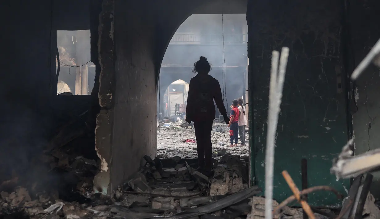 Seorang gadis Palestina memeriksa kerusakan setelah serangan Israel terhadap gedung sekolah Yafa, di Kota Gaza pada 23 April 2025. (Omar AL-QATTAA/AFP)