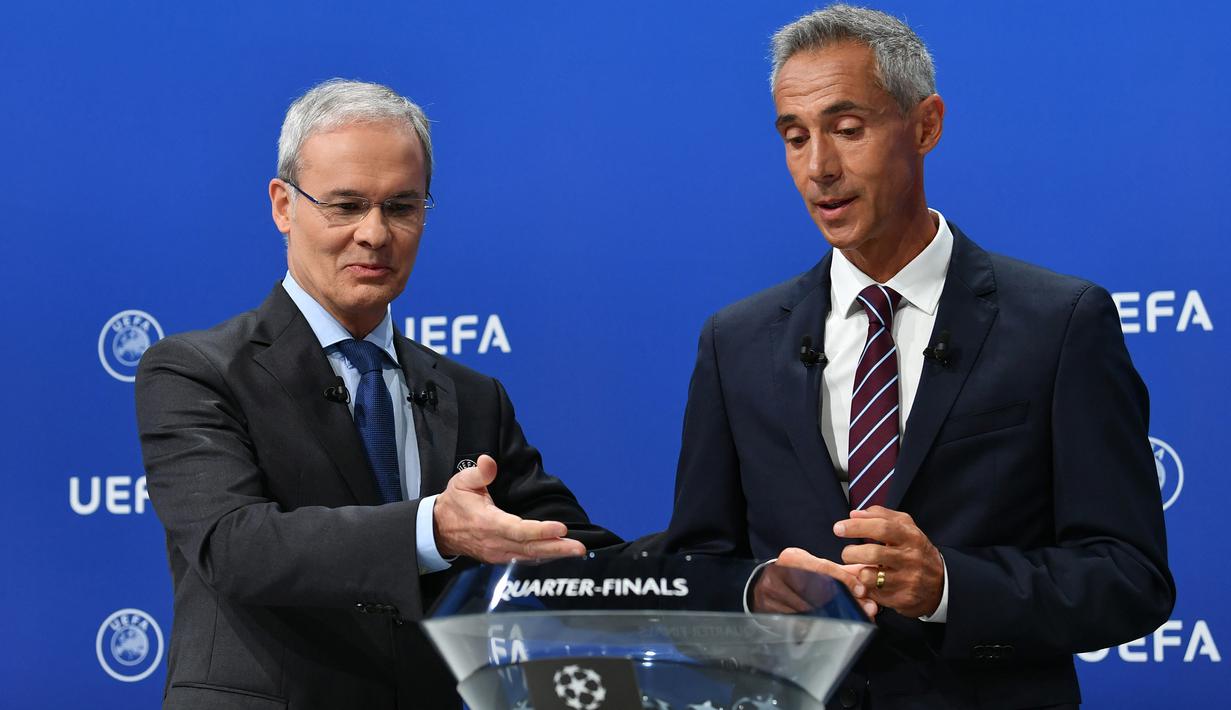 Wakil Sekjen UEFA, Giorgio Marchetti dan Paulo Sousa, saat melakukan drawing perempat final Liga Champions di markas UEFA, Nyon, Jumat (10/7/2020). Rencananya laga leg kedua 16 besar Liga Champions akan digelar pada Agustus 2020 mendatang. (AFP/Harold Cunningham/UEFA)