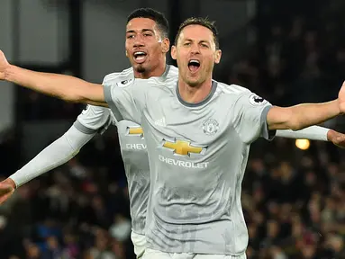 Pemain Manchester United, Nemanja Matic (kanan) merayakan gol bersama Chris Smalling saat melawan Crystal Palace pada lanjutan Premier League di Selhurst Park, London, (5/3/2018). Manchester United menang 3-2. (AFP/Glyn Kirk)