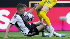 Pemain Timnas Jerman, Matthias Gunter (kiri), berusaha merebut bola dari pemain Ukraina, Artem Dovbyk, dalam laga persahabatan internasional FIFA Matchday 2023 yang digelar di Weserstadion, Bremen, Senin (12/6/2023) malam WIB. (AP Photo/Martin Meissner)
