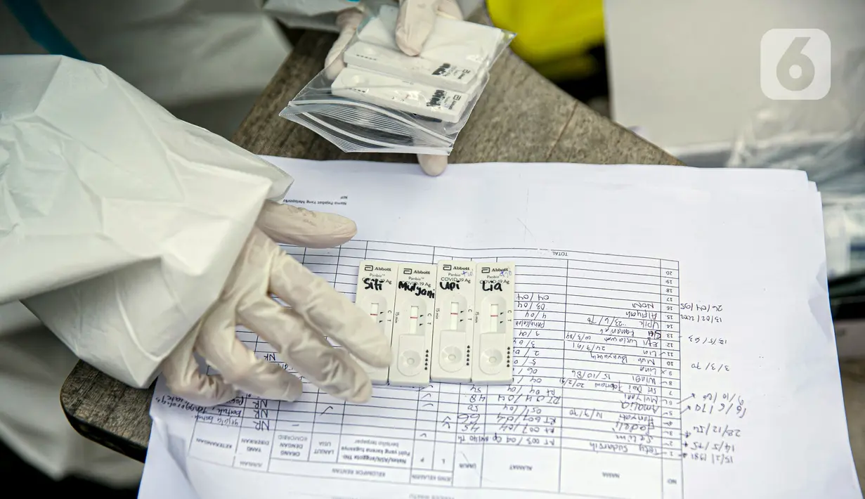 Petugas medis menata alat uji swab antigen COVID-19 di lokasi pengungsi banjir di Universitas Borobudur, Cipinang Melayu, Jakarta, Minggu (21/2/2021). Pengungsi diwajibkan menjalani swab antigen untuk mencegah penyebaran COVID-19. (Liputan6.com/Faizal Fanani)
