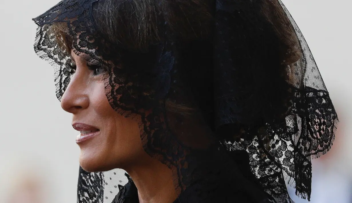 Ibu Negara AS, Melania Trump setibanya di halaman San Damaso, Vatikan untuk melakukan pertemuan dengan Paus Fransiskus, Rabu (24/5). Dalam pertemuan tersebut, Melania mengenakan kerudung renda warna hitam di kepalanya. (AP Photo/Gregorio Borgia)