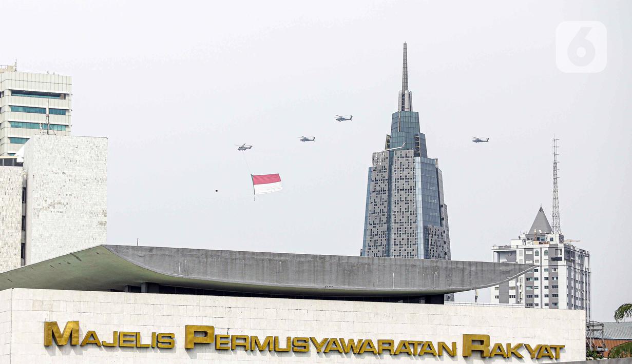 Helikopter TNI AU mengibarkan bendera Merah Putih raksasa di kawasan Gedung DPR RI, Jakarta, Selasa (5/10/2021). Bendera raksasa ini dikibarkan dari timur ke barat langit Jakarta dalam rangka memperingati Hut ke-76 TNI. (Liputan6.com/Faizal Fanani)