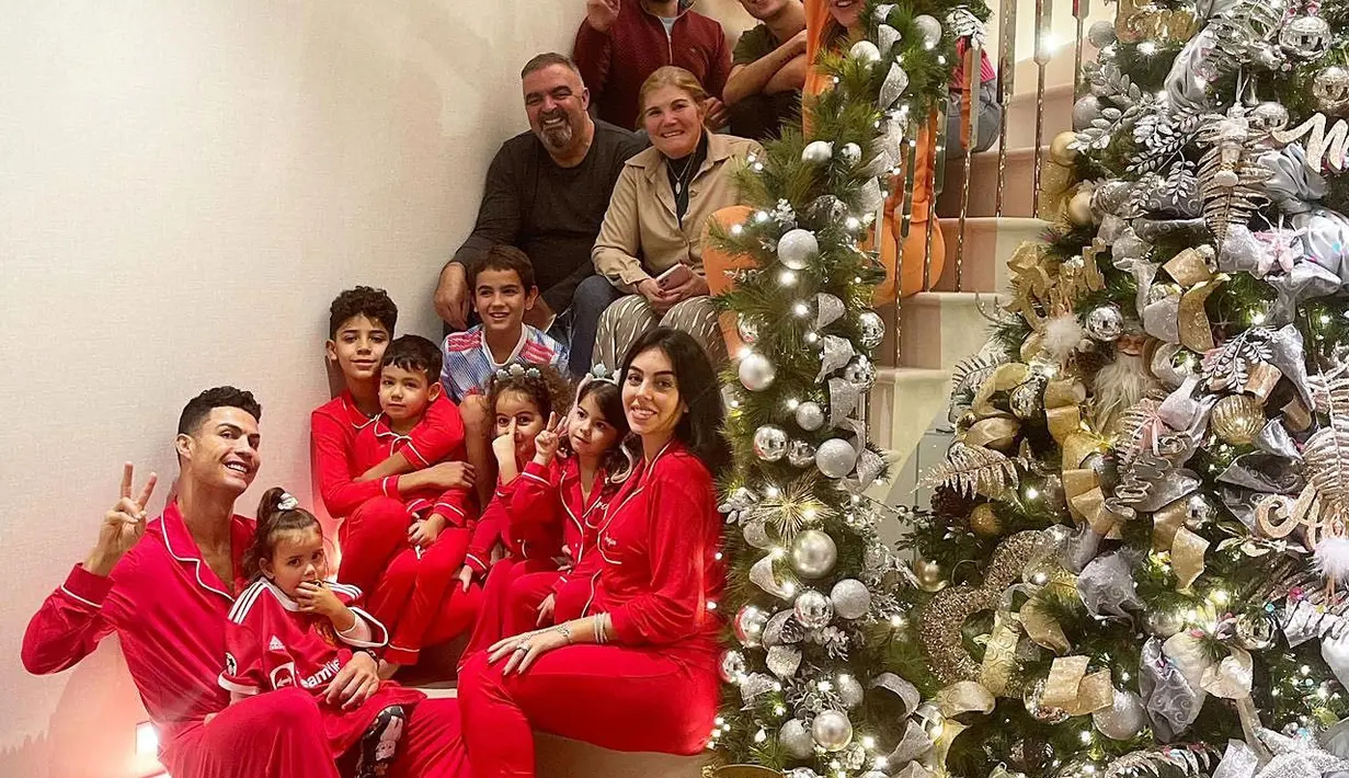Cristiano Ronaldo dan Georgina Rodriguez melewati momen Natal bersama keluarga besarnya. Ronaldo dan Geo kompak memakai piyama warna merah bersama keempat anaknya. (Foto: Instagram @georginagio)
