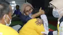 Seorang kerabat memeluk korban kapal penummpang KMP Yunicee yang tenggelam di Banyuwangi, Jawa Timur, Rabu (30/6/2021). KMP Yunicee tenggelam karena terseret arus dan mengalami kemiringan hingga terbalik. (AP Photo)