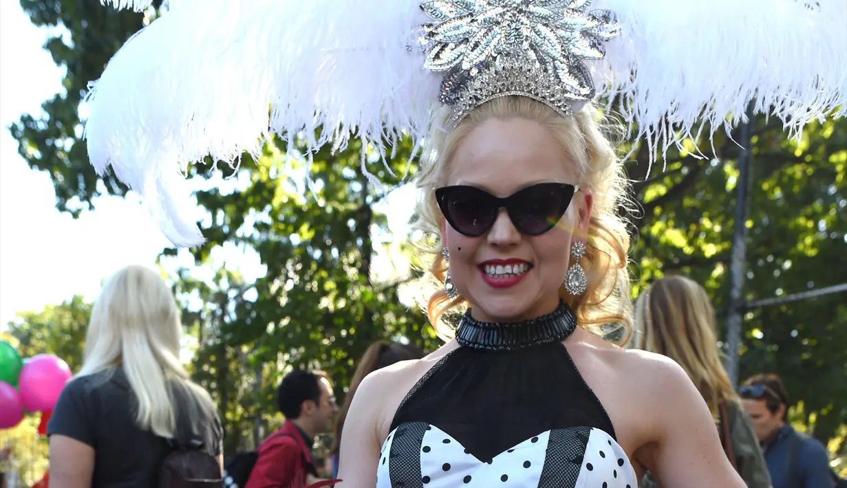 Seorang wanita mengenakan kostum berpose dengan anjingnya saat Parade Halloween Anjing Tahunan di Tompkins, New York (21/10). Acara ini diadakan setiap tahunnya di Tompkins Square. (AFP Photo/Timothy A. Clary)