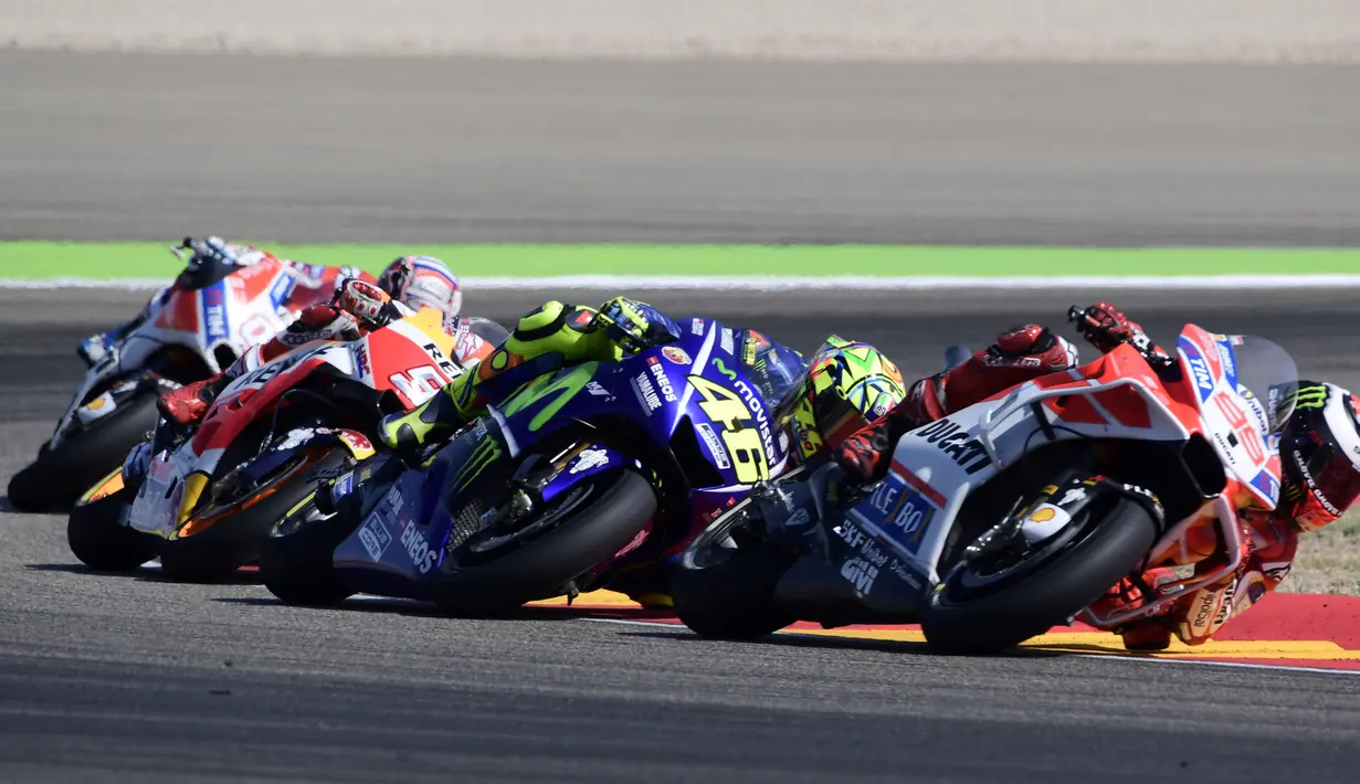 Pembalap Movistar Yamaha, Valentino Rossi (kedua kanan) memacu kendaraannya pada balapan MotoGP Aragon di Spanyol, Minggu (24/9). Juara dunia tujuh kali kelas MotoGP itu memulai balapan dari posisi tiga. (JAVIER SORIANO/AFP)