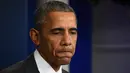 Presiden AS Barack Obama memberikan pernyataan terkait serangan bom di Perancis, Jumat (13/11/2015). Obama berjanji akan membantu Perancis menangkap pelaku serangan bersenjata ini. (AFP Photo/Jim Watson)