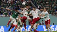 Gelandang Polandia, Grzegorz Krychowiak dan pemain Meksiko, Edson Alvarez melakukan sundulan selama pertandingan grup C Piala Dunia 2022 Qatar di Stadion 974 di Doha, Qatar, Selasa (22/11/2022). Polandia bermain imbang dengan Meksiko dengan skor 0-0. (AP Photo/Martin Meissner)
