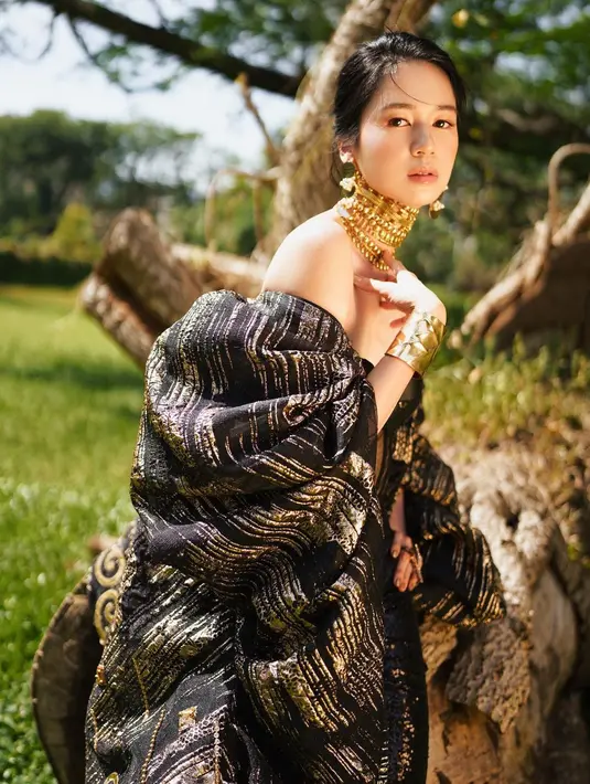 Penampilannya kian memukau dengan layered choker, anting, cincin dan bangle warna emas. [cr: @winstongomez].