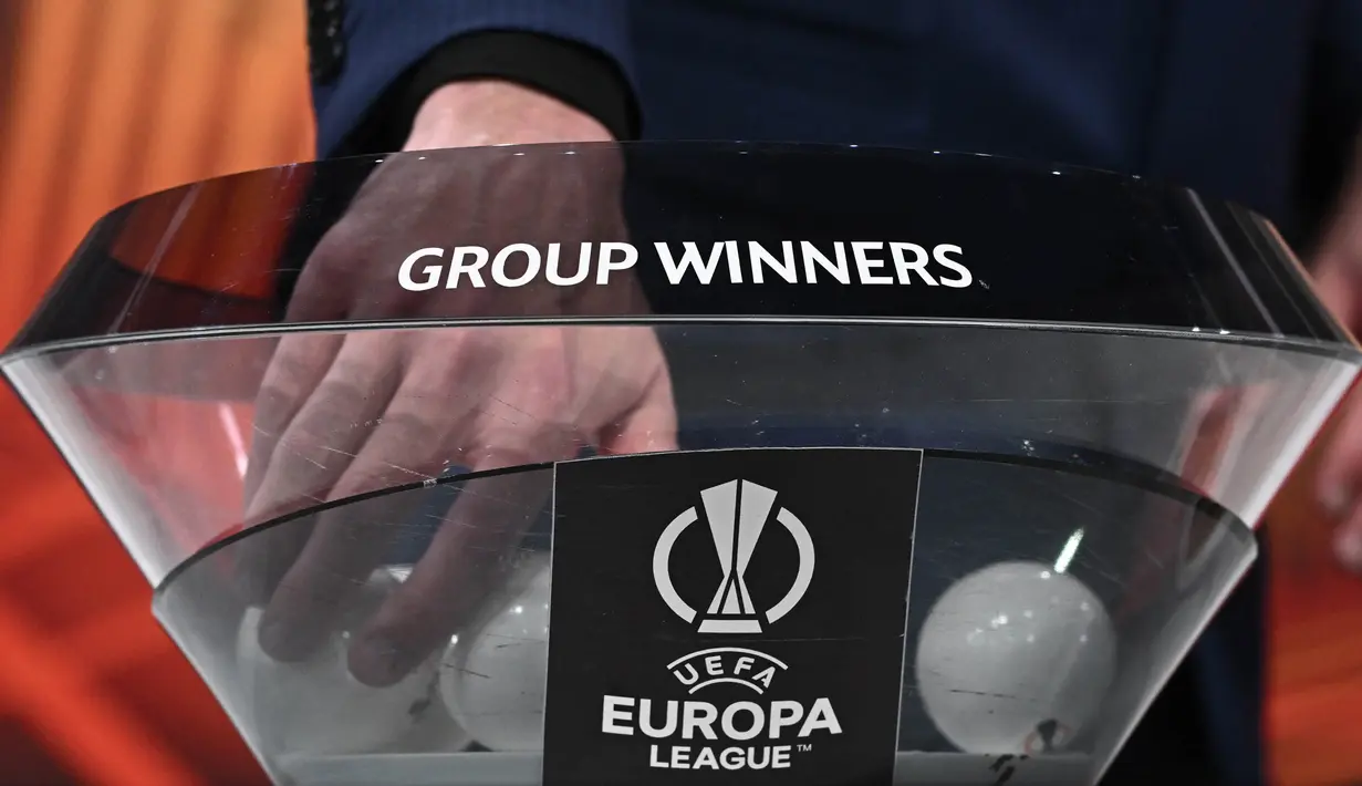 Wakil Sekretaris Jenderal UEFA Giorgio Marchetti mengambil bola dari mangkuk pengundian babak 16 besar turnamen sepak bola Liga Europa 2023-2024 di House of European Football di Nyon, pada 23 Februari 2024. (Fabrice COFFRINI/AFP)