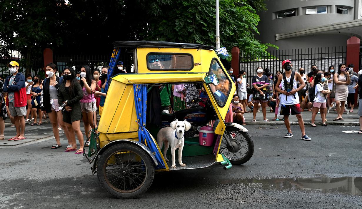 Warga menyelamatkan diri dengan keluar bangunan setelah gempa berkekuatan magnitudo 7,1 terasa di Manila, Filipina, Rabu (27/7/2022). Belum diketahui apakah ada korban jiwa akibat gempa ini. (JAM STA ROSA/AFP)