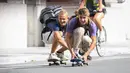 Orang-orang bermain papan luncur di sebuah jalan dalam acara Hari Minggu Bebas Kendaraan Bermotor (Car Free Sunday) di Brussel, Belgia, pada 20 September 2020. (Xinhua/Zheng Huansong)