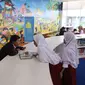 Siswa Sekolah Dasar (SD) membaca buku di ruang baca Perpustakaan Nasional (Perpusnas), Jakarta, Selasa (18/2/2020). Selain megah dan memiliki koleksi lengkap, Perpusnas juga menyediakan ruangan perpustakaan untuk anak-anak, layanan untuk penyandang disabilitas dan lansia. (Liputan6.com/Angga Yuniar)