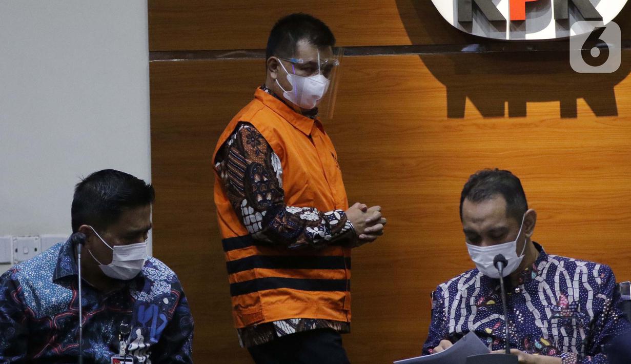 Bupati Bandung Barat Aa Umbara Sutisna (tengah) jelang rilis penahanan di Gedung KPK, Jakarta, Jumat (9/4/2021). KPK menahan Aa Umbara dan anaknya Andri Wibawa terkait dugaan korupsi pengadaan barang tanggap darurat pandemi COVID-19 pada Pemkab Bandung Barat 2020. (Liputan6.com/Helmi Fithriansyah)