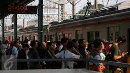 Sejumlah penumpang bersiap menaiki kereta Comuter Line di Stasiun Manggarai, Jakarta, Selasa (28/3). Stasiun Manggarai dipadati penumpang yang hendak berlibur pada Hari Raya Nyepi Tahun Baru Saka 1939. (Liputan6.com/Faizal Fanani)