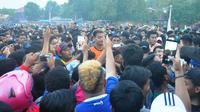 Kurnia Meiga diadang puluhan Aremania yang ingin berfoto dan minta tandang saat tampil sebagai tamu di sebuah turnamen di Cepu. (Bola.com/Iwan Setiawan)