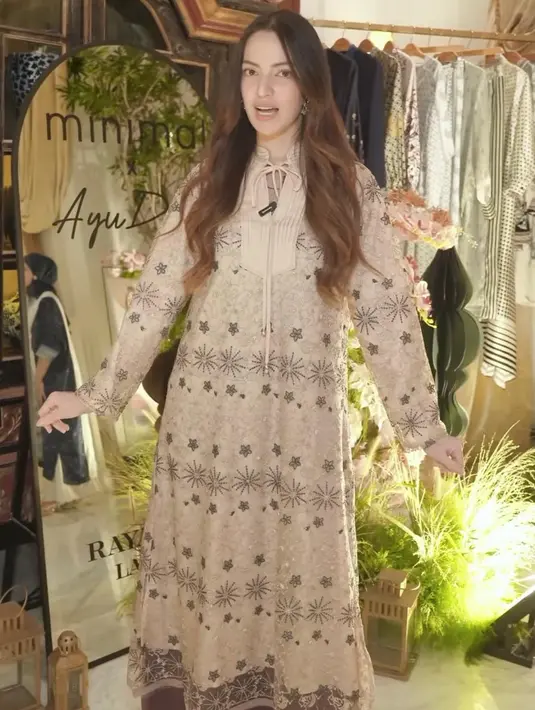 Alternatif lainnya adalah maxi dress warna beige dengan full pattern minimalis seperti yang dikenakan Nia Ramadhani, memberikan kesan simpel namun tetap stylish.