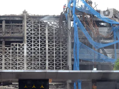 Pekerja membongkar bangunan Gedung Kejaksaan Agung setelah terbakar di Jakarta, Rabu (14/4/2021). Gedung utama Kejaksaan Agung mulai dibongkar setelah mengalami kebakaran pada 22 Agustus 2020. (merdeka.com/Imam Buhori)