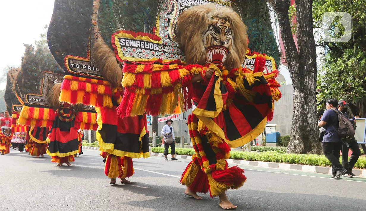Seniman menampilkan tarian tradisional Reog Ponorogo dalam pawai budaya di kawasan Patung Kuda, Jakarta, Minggu (27/8/2023). (Liputan6.com/Herman Zakharia)