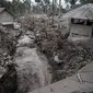 Rumah-rumah rusak akibat erupsi Gunung Semeru terlihat di Desa Sumber Wuluh, Lumajang, Jawa Timur, Senin (6/12/2021). Desa Sumber Wuluh luluh lantak diterjang erupsi Semeru mengakibatkan puluhan rumah rusak dan ratusan warga mengungsi. (Juni Kriswanto/AFP)