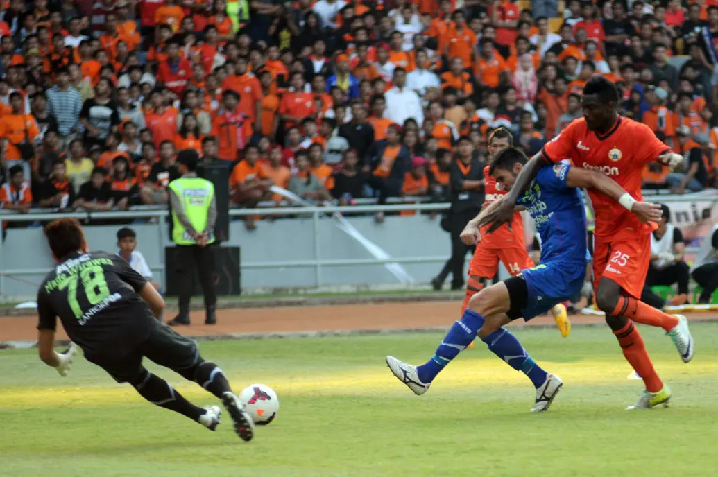 Pemain belakang Persib Bandung, Vladimir Vujovic (tengah), menahan laju serangan Edi Foday Boakay (Persija Jakarta) saat berlaga di Stadion GBK, (10/8/2014). (Liputan6.com/Helmi Fithriansyah)