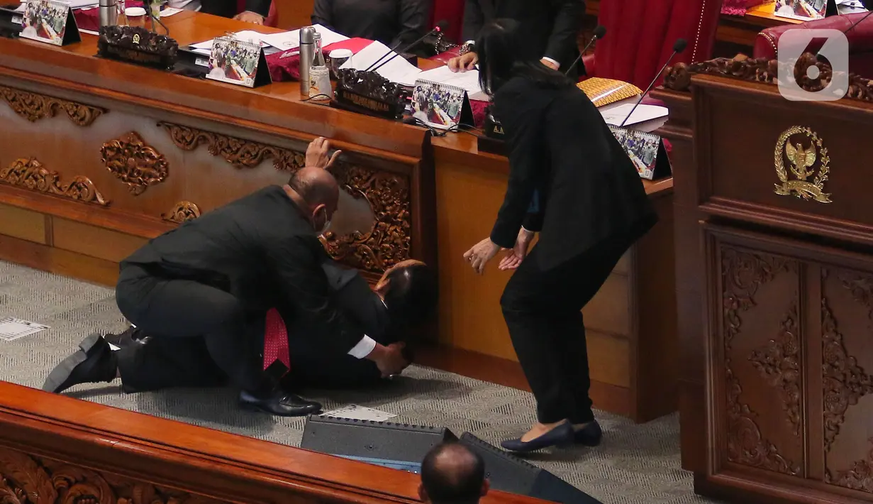 Wakil Ketua Banggar DPR RI Muhidin Muhammad Said terjatuh usai memberikan laporan hasil pembahasan RAPBN 2023 di Rapat Paripurna ke-26 Masa Persidangan V Tahun Sidang 2021-2022 di Gedung nusantara III, Jakarta, Kamis (30/6/2022). Belum diketahui kenapa Wakil Banggar Muhidin sampai terjatuh dan dibawa keruang medis. (Liputan6.com/Angga Yuniar)