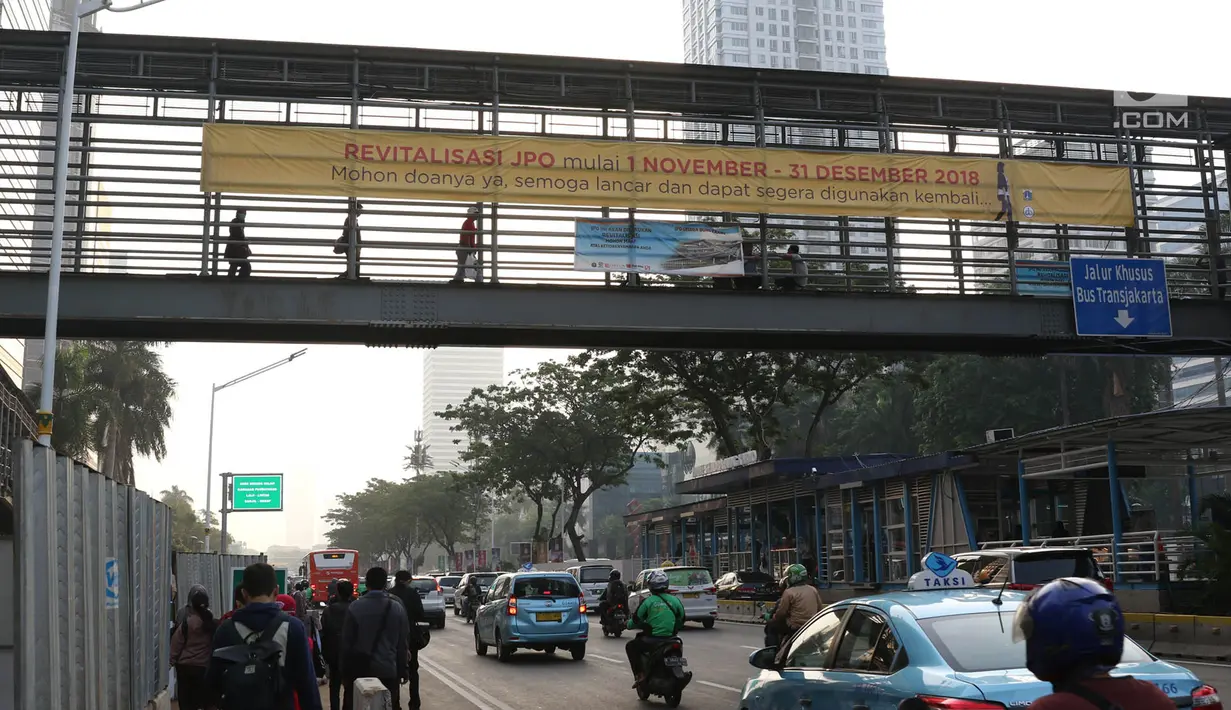 Spanduk peringatan revitalisasi Jembatan Penyeberangan Orang (JPO) di JPO Jalan Sudirman, Jakarta, Selasa (6/11). Tiga JPO yang akan direvitalisasi JPO Bundaran Senayan, JPO Polda Metro Jaya, dan JPO di Stadion Utama GBK. (Liputan6.com/Immanuel Antonius)