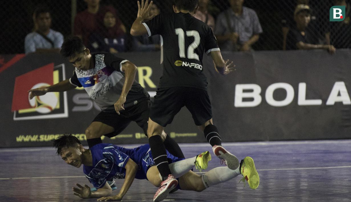 Pemain Al-Falah dijatuhkan pemain Kerambah FC pada laga Grand Final Futsal Battle di Mall Taman Anggrek, Jakarta, Minggu (14/10). Kerambah FC juara melalui adu penalti. (Bola.com/Vitalis Yogi Trisna)