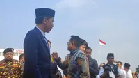 Presiden Joko Widodo (Jokowi) di acara Apel Hari Santri 2023 yang digelar di Tugu Pahlawan, Surabaya, Jawa Timur, Minggu (22/10/2023). (Liputan6.com/Dicky Agung Prihanto)