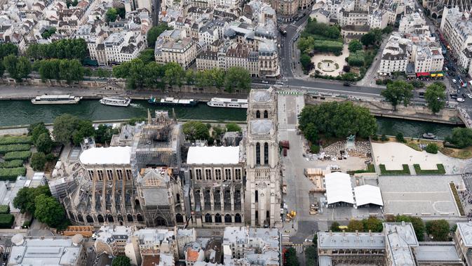 Katedral Notre Dame sedang menjalani restorasi setelah rusak parah akibat kebakaran hebat, Paris, Prancis, Minggu (14/7/2019). Proses ini diharapkan berlangsung hingga musim gugur. (Kenzo TRIBOUILLARD/AFP)