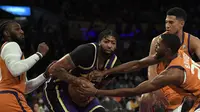 Pemain Los Angeles Lakers Anthony Davis dikelilingi Mikal Bridges, Jae Crowder, dan Devin Booker dari Phoenix Suns dalam pertandingan NBA di Staples Center, Sabtu (23/10/2021). (KEVORK DJANSEZIAN / GETTY IMAGES NORTH AMERICA / GETTY IMAGES VIA AFP)