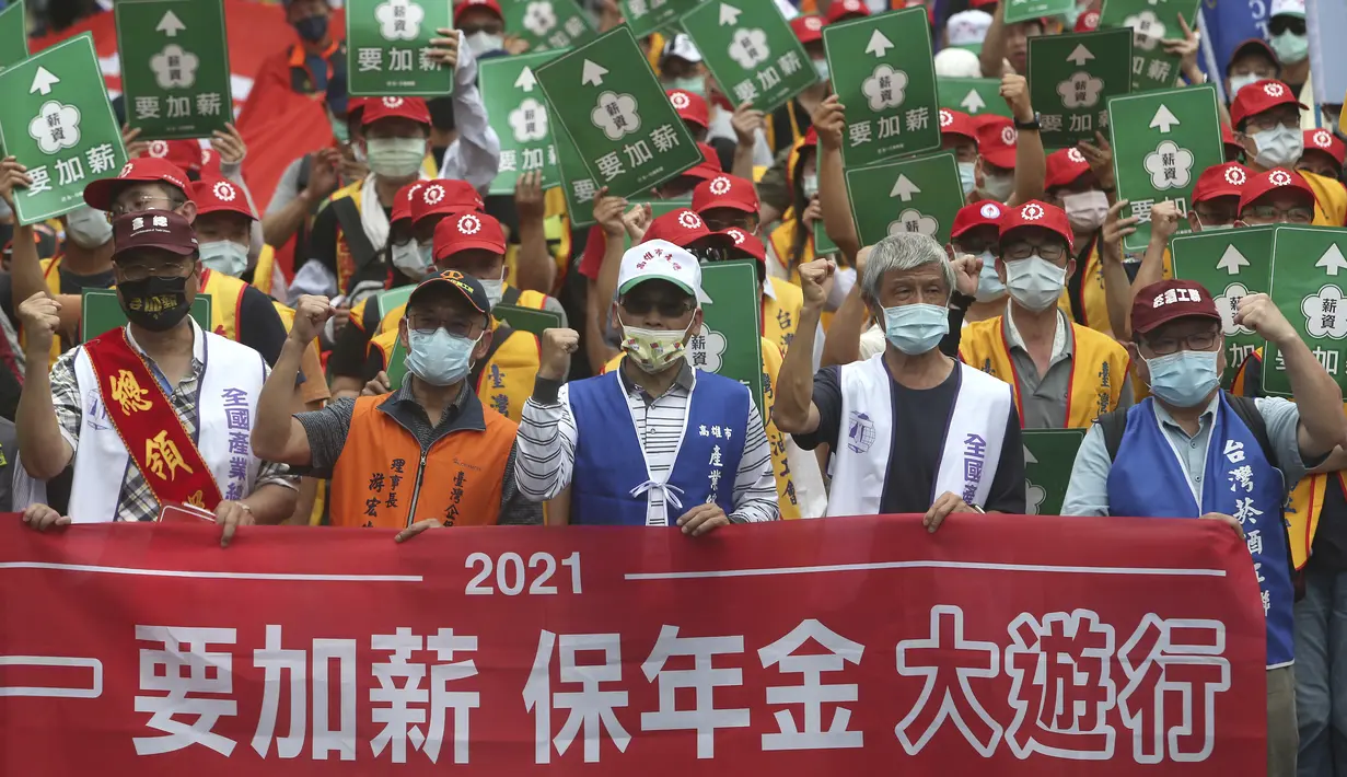 Para pekerja Taiwan berteriak dan memegang slogan bertuliskan "Kenaikan Gaji, Amankan Anuitas" saat unjuk rasa May Day atau Hari Buruh Internasional  di Taipei, Sabtu (1/5/2021). Setiap tahun, Hari Buruh Internasional atau May Day dirayakan di berbagai negara pada 1 Mei. (AP Photo/Chiang Ying-ying)