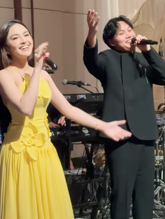 Mahalini hadir mengenakan long dress kuning dengan aksen bunga 3D. Rizky Febian juga hadir untuk mengisi acara mengenakan beskap hitam. [@kekeadiba]