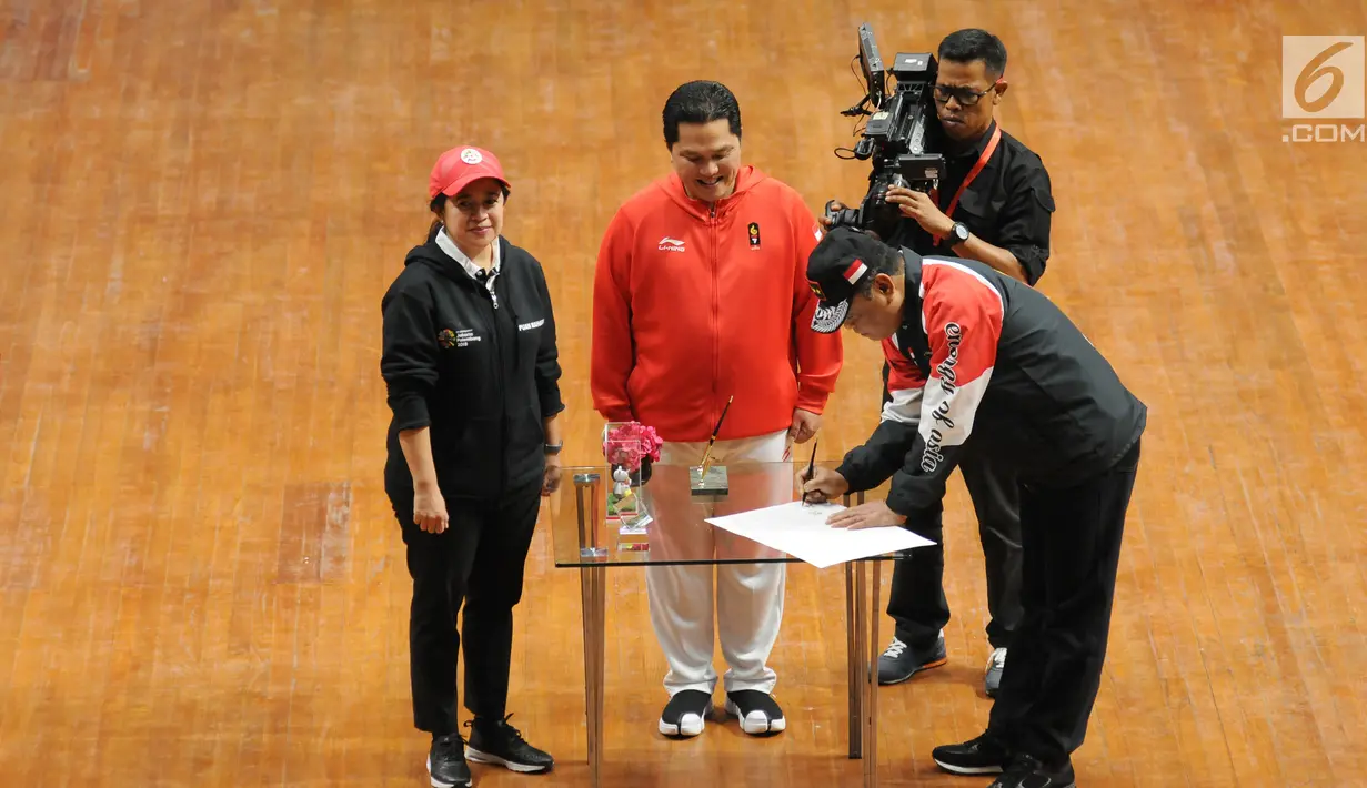 Ketua Kontingen Indonesia untuk Asian Games 2018, Komjen Pol Syafruddin (kanan) menandatangani nota integritas saat upacara pengukuhan di Istora Senayan, Jakarta, Minggu (5/8). Upacara dipimpin Menko PMK Puan Maharani. (Liputan6.com/Helmi Fithriansyah)